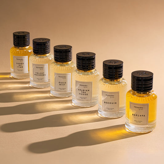 Set of perfume bottles with labels on a beige background